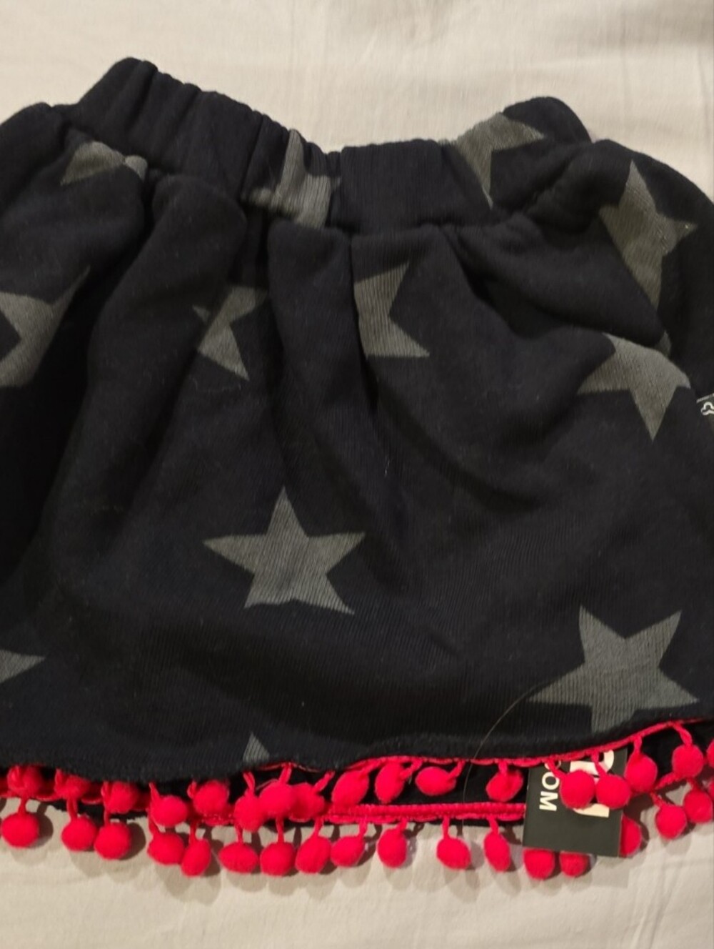 nununu Black Knit Skirt with Gray Star and Red Accent Patch
